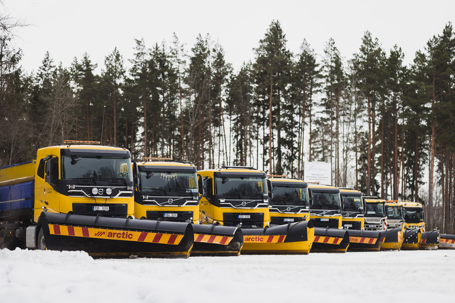 front view of nine trucks in the snow